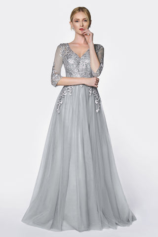 Magical flowy layered A-line tulle gown with three quarter sleeve and lace bodice.